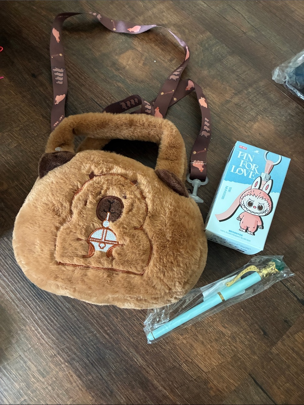 Popmart The Monsters Keychain and a unbranded capybara plush crossbody with pen